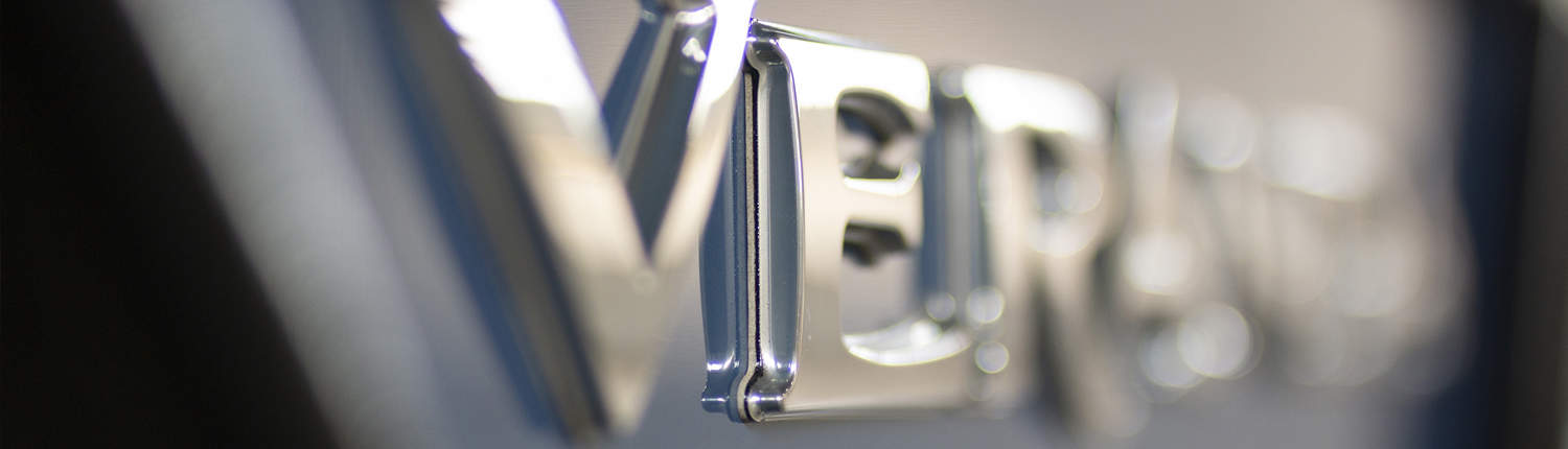 Chrome Veranda lettering on the side panel of a pontoon with shallow depth of field.
